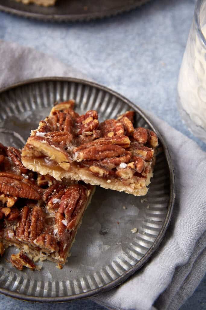 pecan pie bars on a gray plate. 