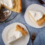 slices of vanilla pudding pie on white plates.