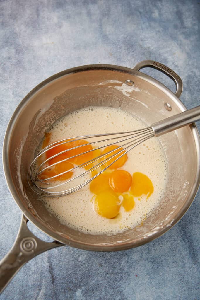 milk, evaporated milk, and egg yolks in a saucepan.