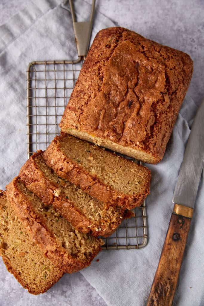 sliced pineapple zucchini bread on a wire rack. 