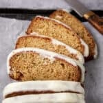 sliced pineapple zucchini bread with a knife in the background.
