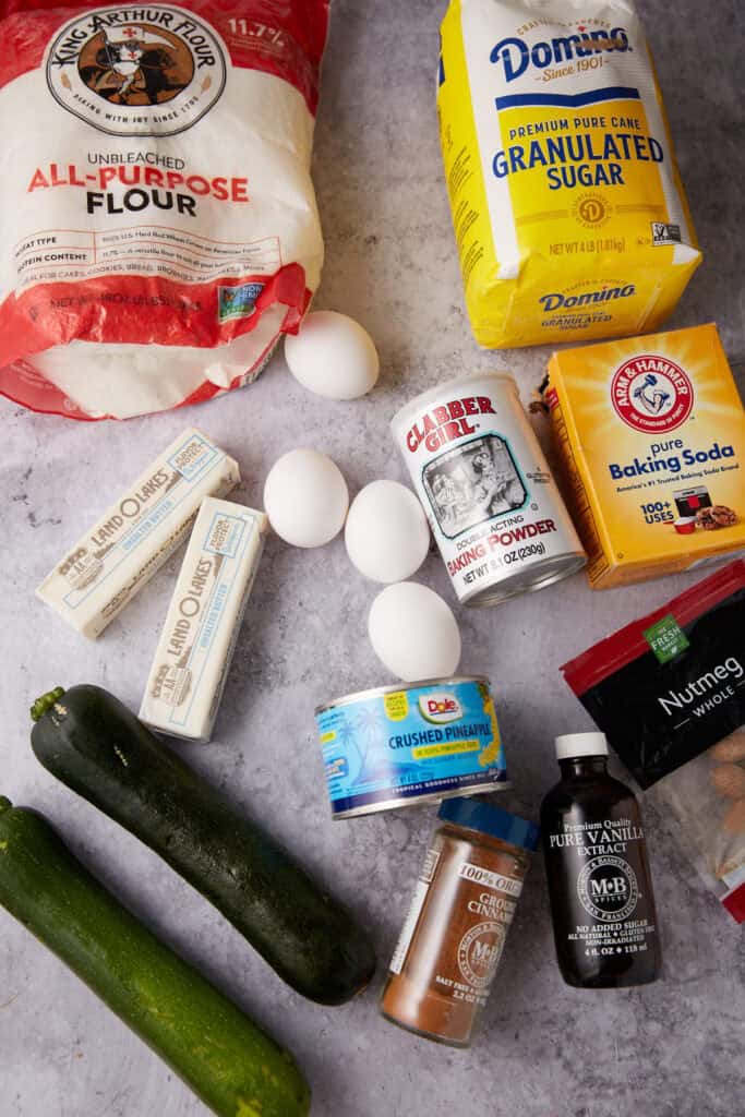 pineapple zucchini bread ingredients on a gray background