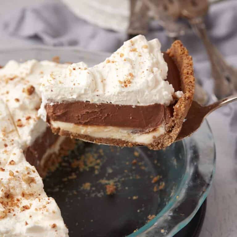 A slice of possum pie being removed from a pie dish.