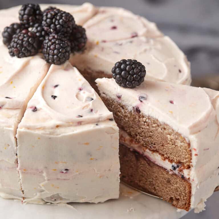 a piece of blackberry jam cake being lifted out.