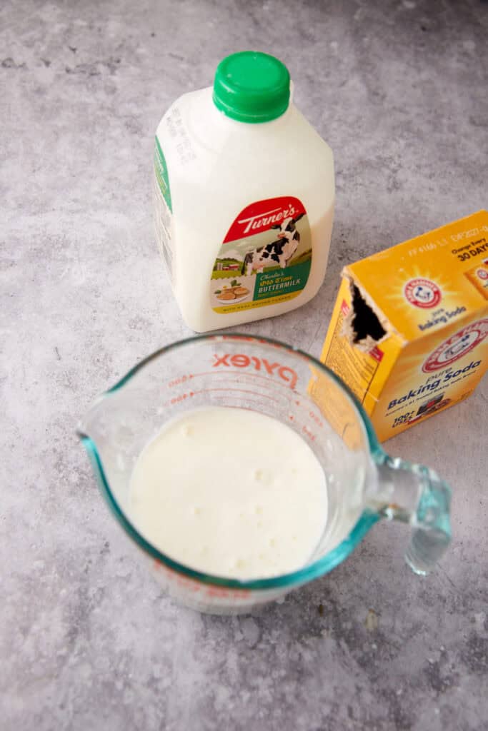 buttermilk and baking soda mixed into a glass measuring cup.