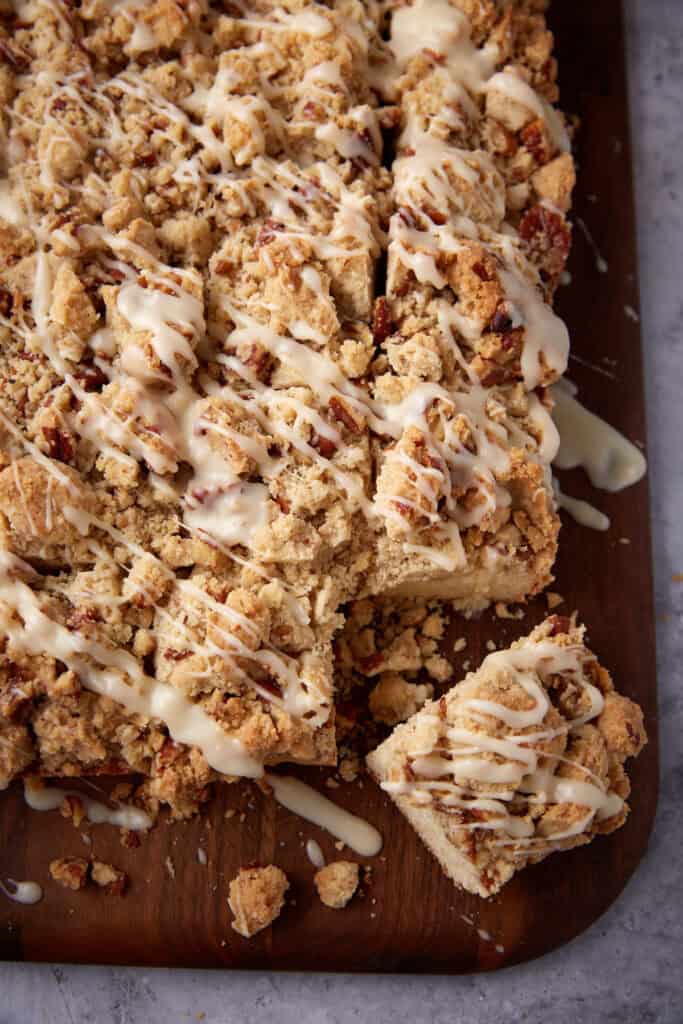 up close view of crumb cake cut into slices with one slice coming out. 