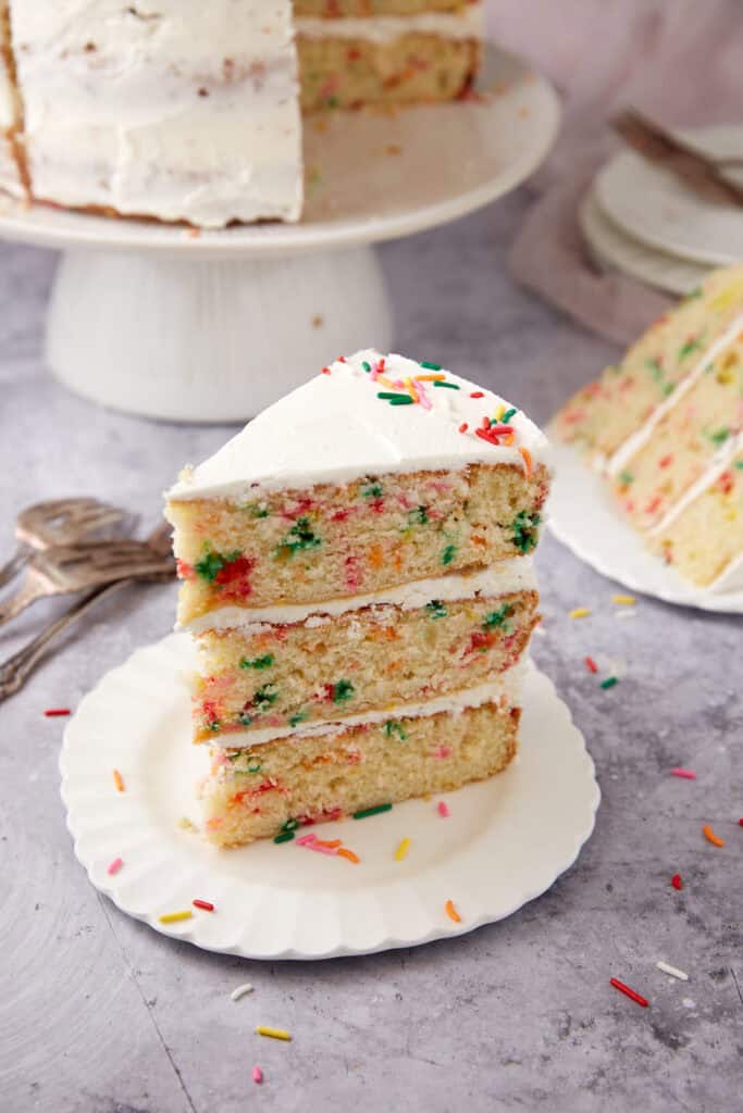 slice of confetti cake on a white plate.