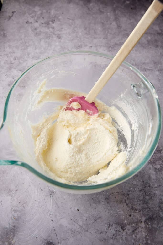 beaten butter and sugar in a glass bowl with a spatula.