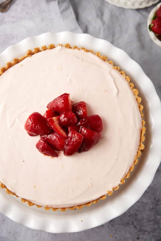 frozen strawberry pie topped with marinated strawberries.