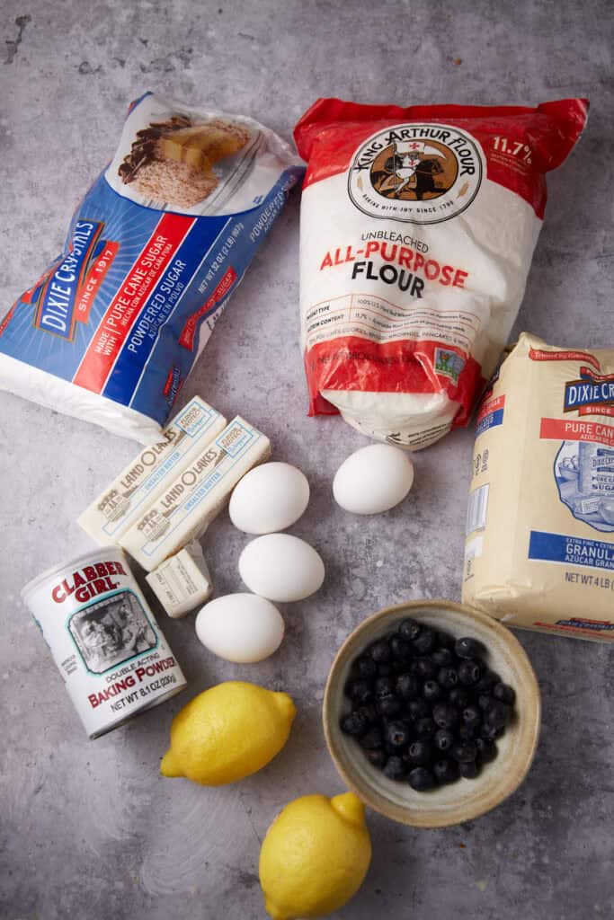 lemon blueberry bars ingredients on a gray background.