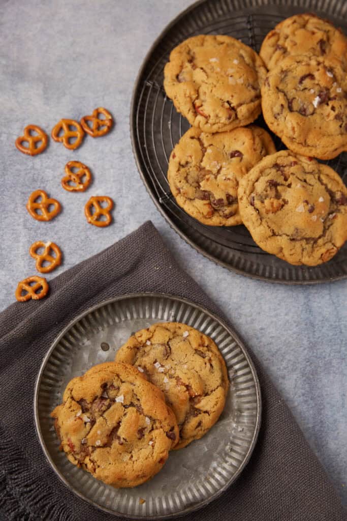 peanut butter pretzel cookies on a plate with a plate of cookies and pretzels on the side.