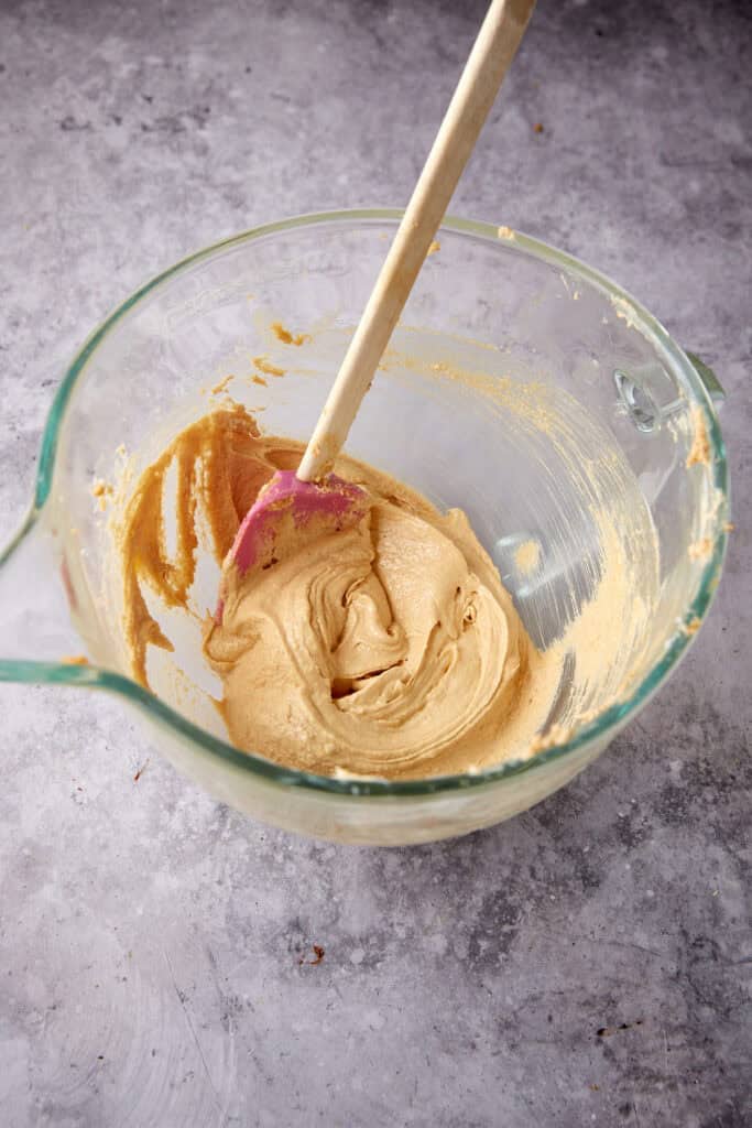 butter and sugar beaten in a glass bowl with a spatula.