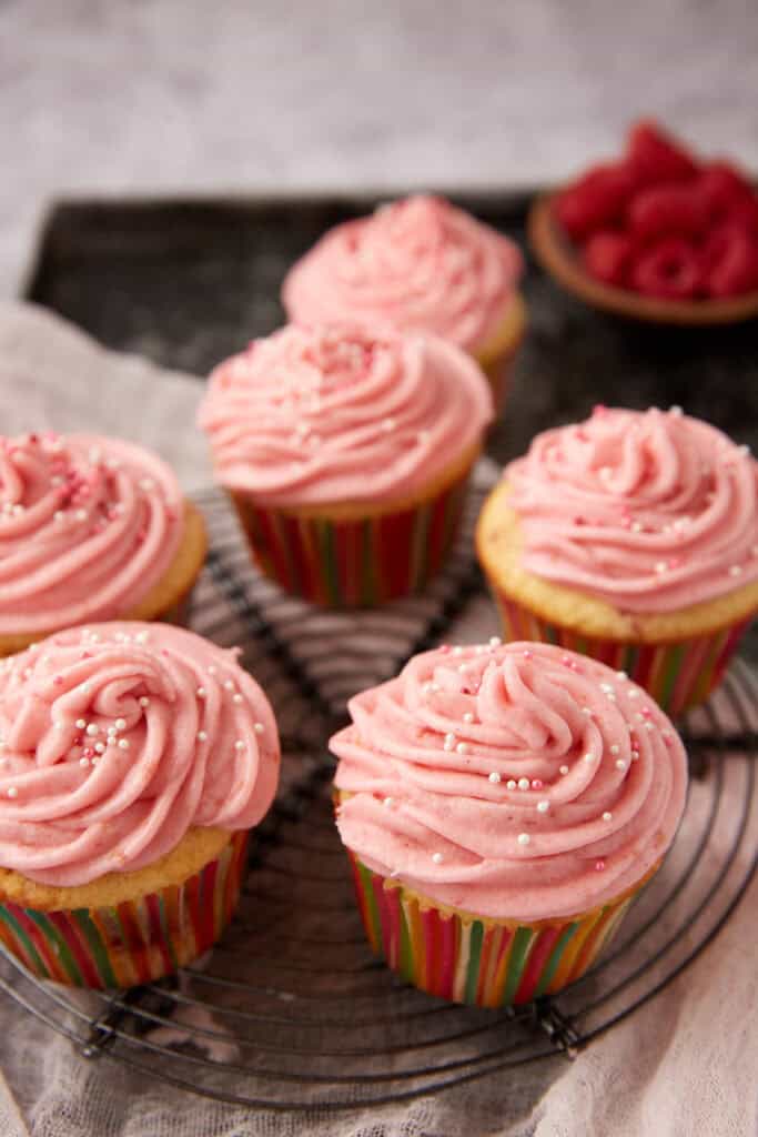 raspberry cupcakes on a cupcake stand.