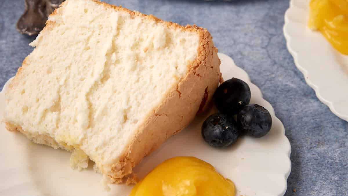 Three slices of angel food cake with lemon curd and blueberries.