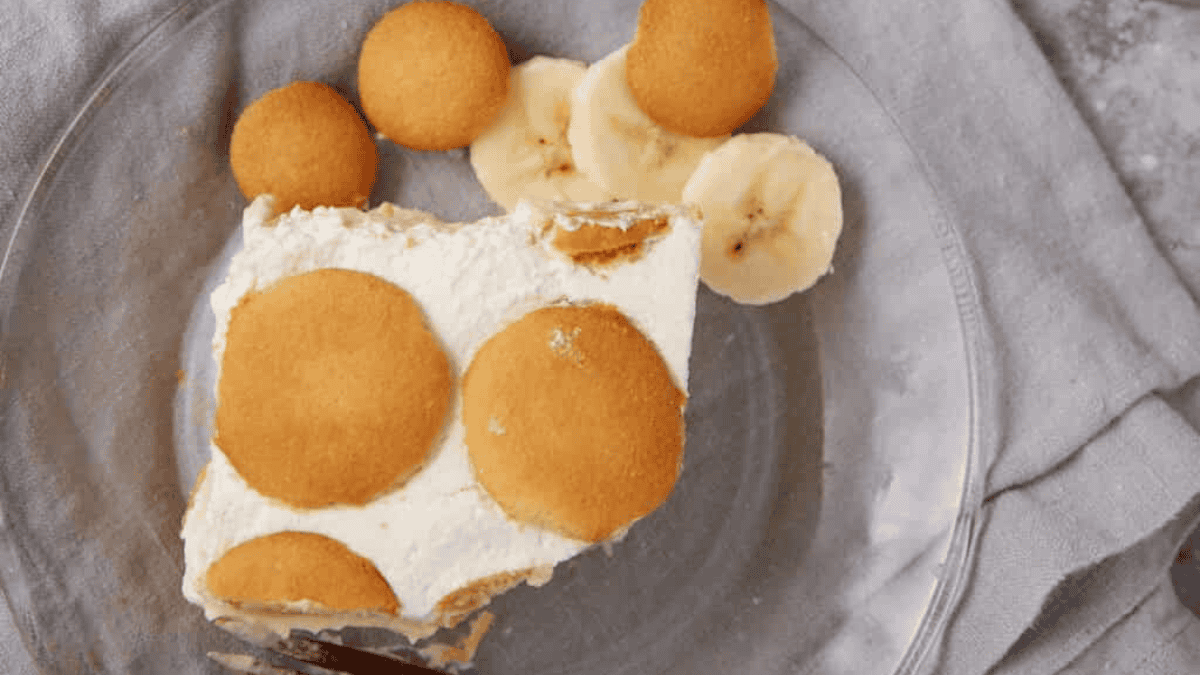 banana pudding poke cake slice on a plate.