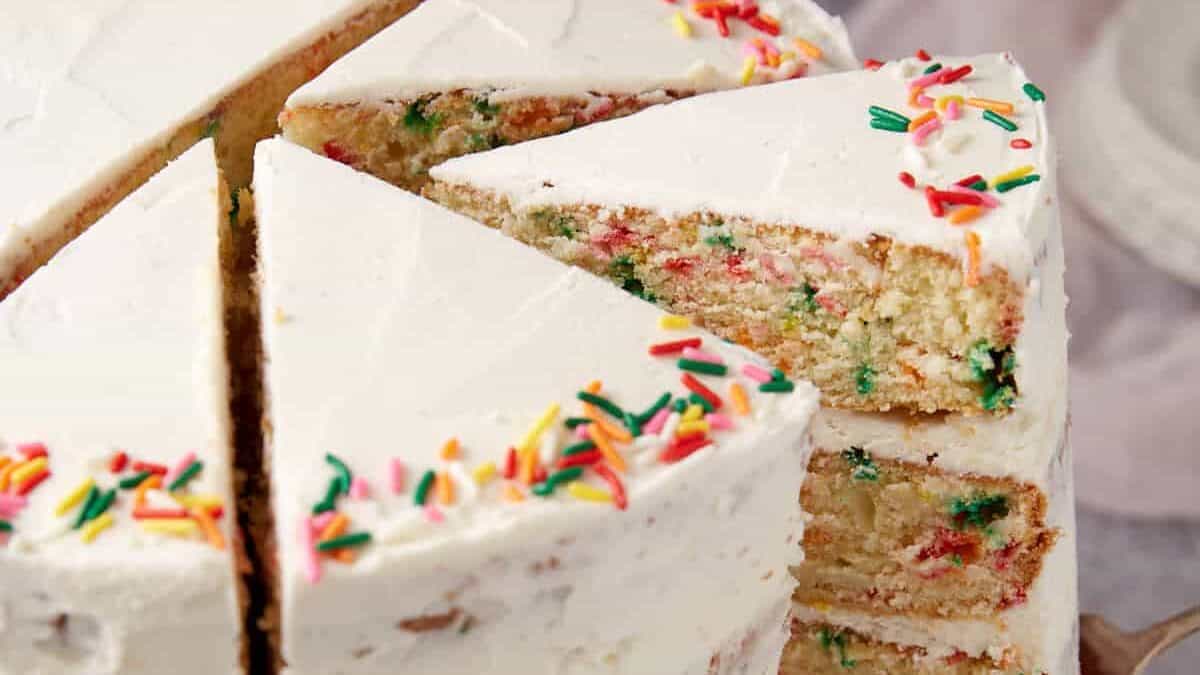 Confetti cake topped with sprinkles and frosting.