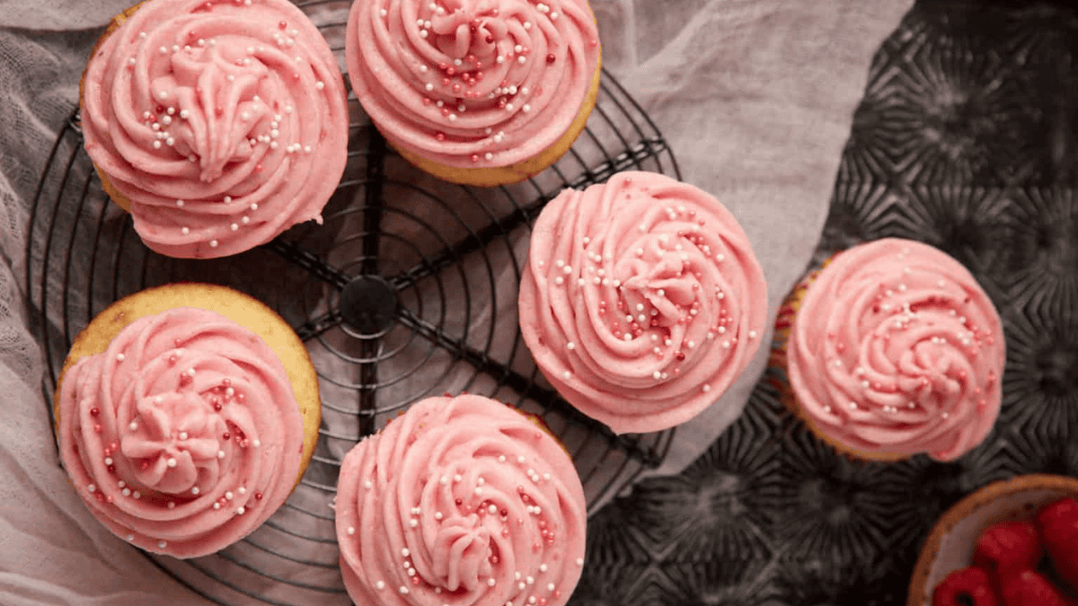 lemon raspberry cupcakes on a cooling rack.