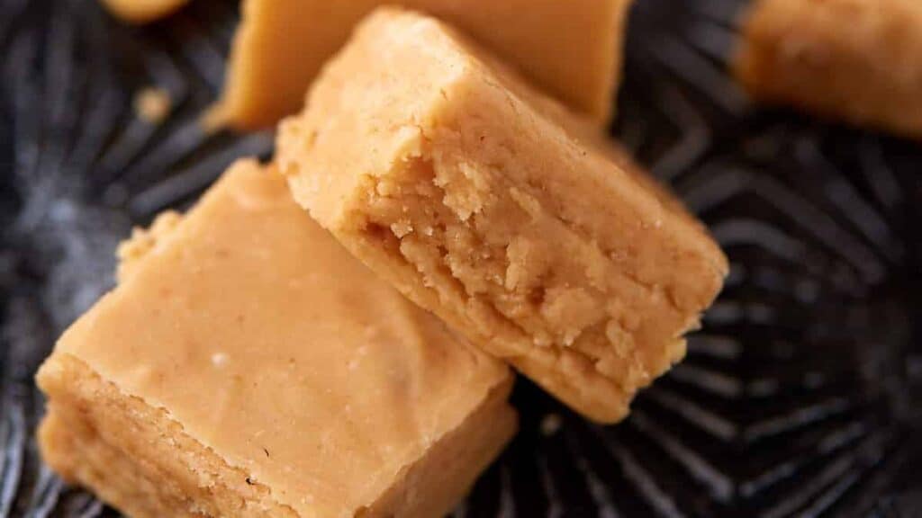 Pieces of peanut butter fudge on a tray.