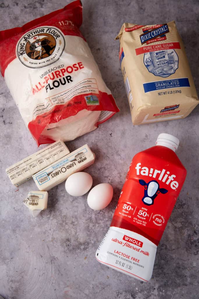 Ingredients for a homemade pie dough including flour, eggs, milk, and butter.