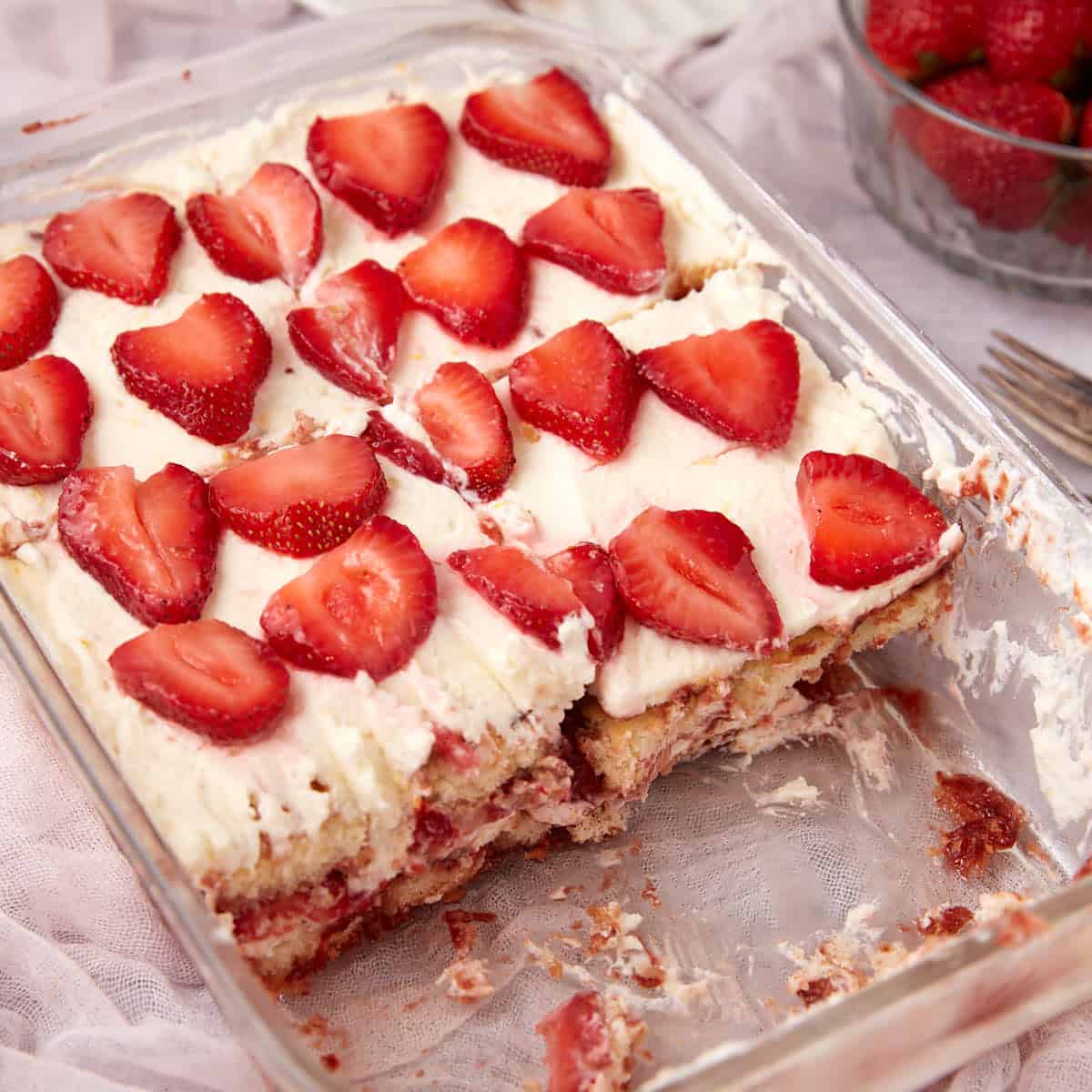 A square dish with strawberry tiramisu.