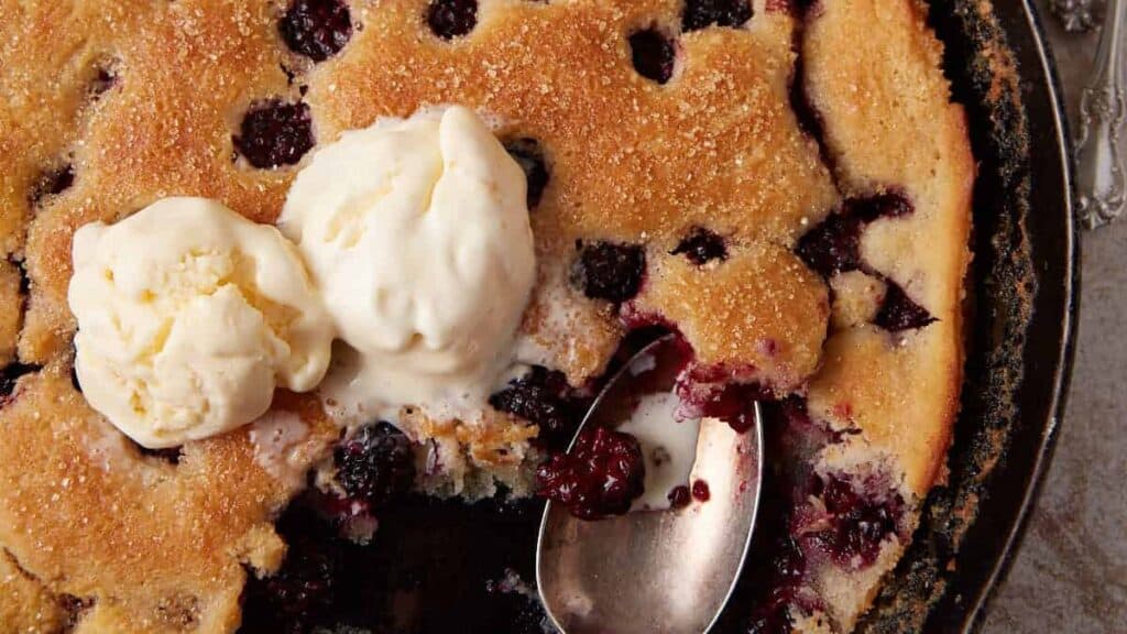 Ice cream topped blackberry skillet cobbler.