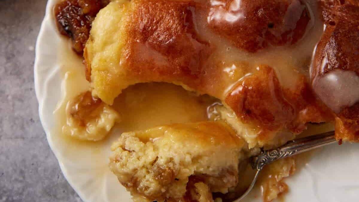 A single serving of bread pudding with vanilla sauce.