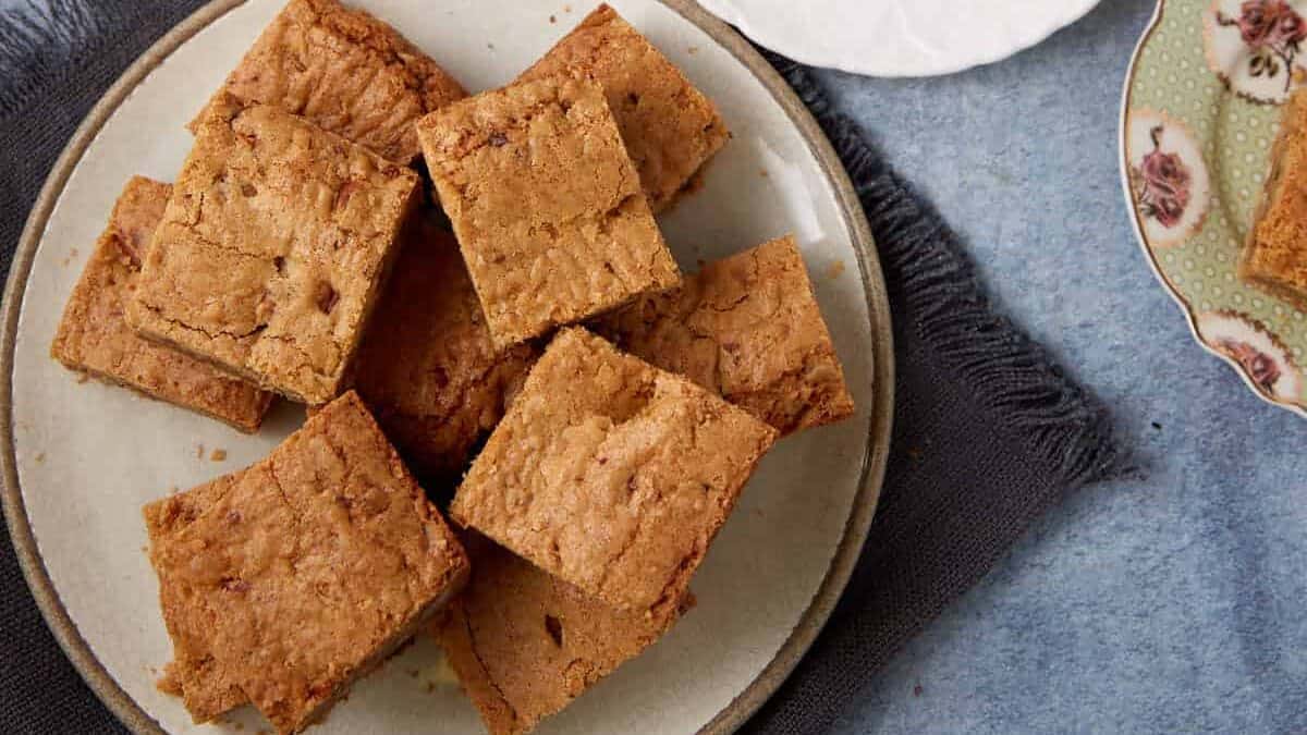 brown butter blondies on a large plate and two smaller plates.