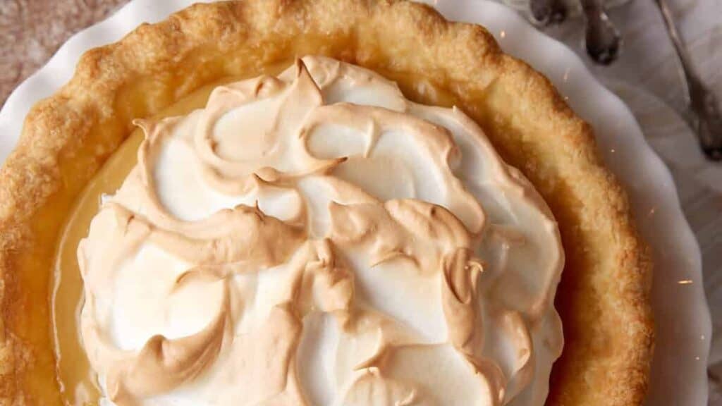 brown sugar pie with meringue on a white plate.