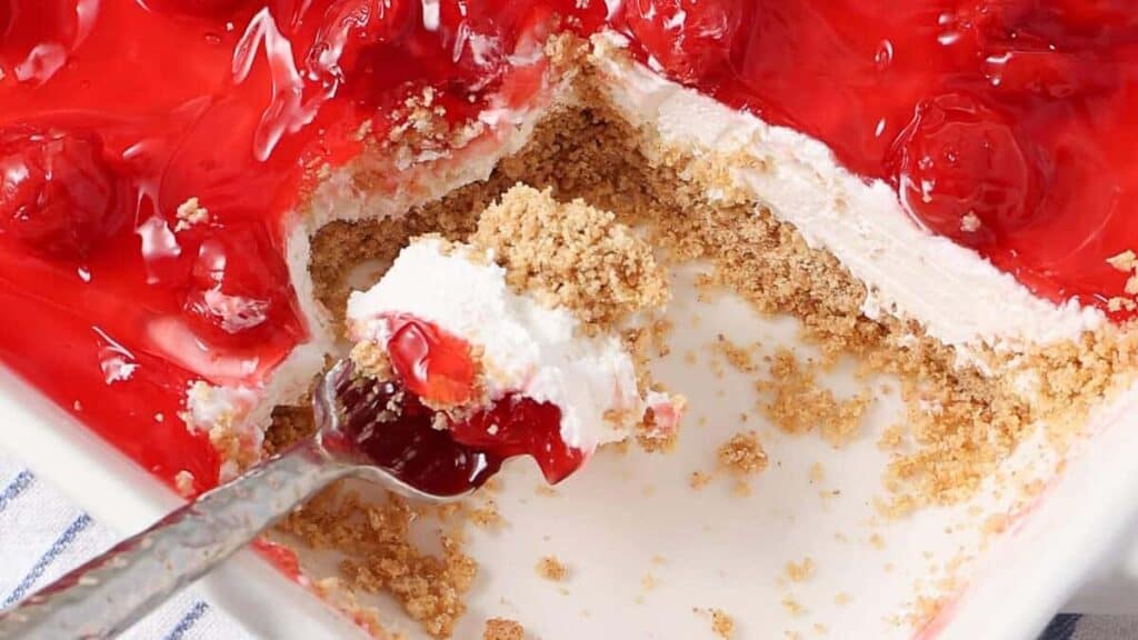 close up of no bake cherry delight in a white dish.