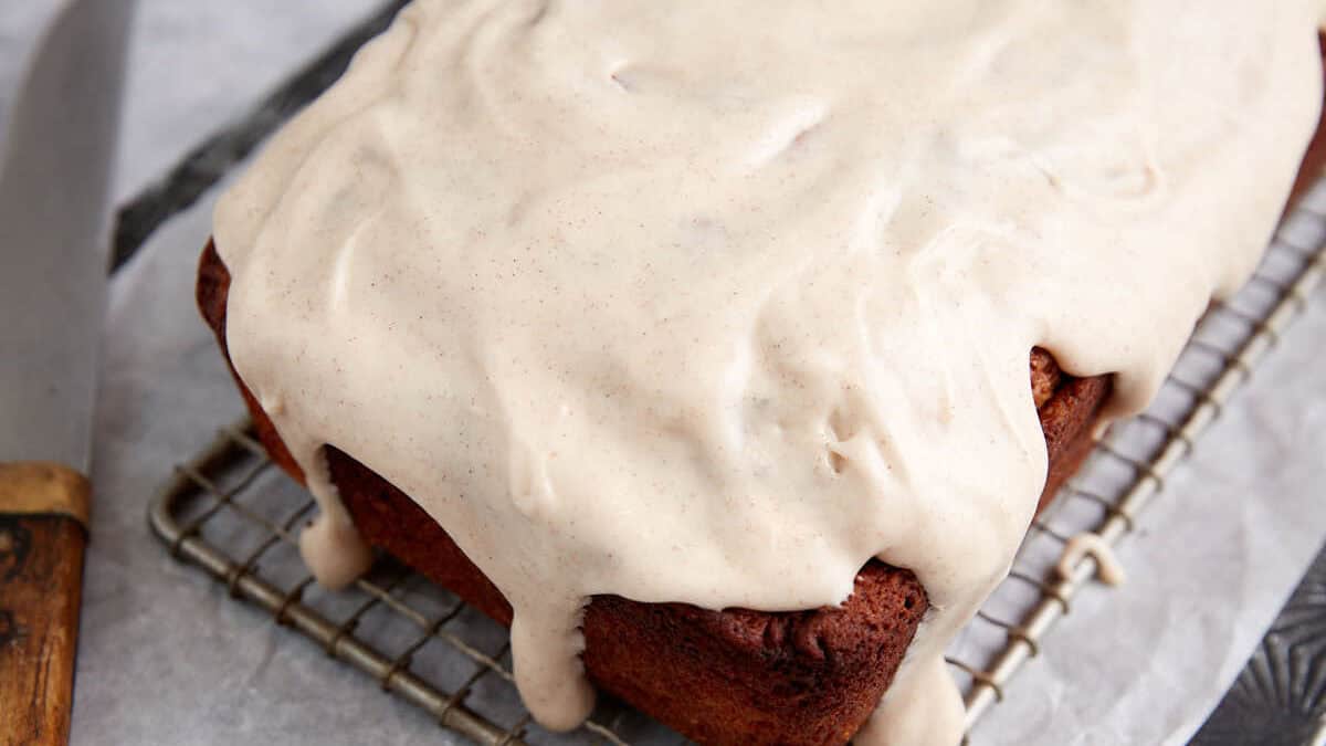 The cinnamon swirl bread with frosting dripping down the sides.