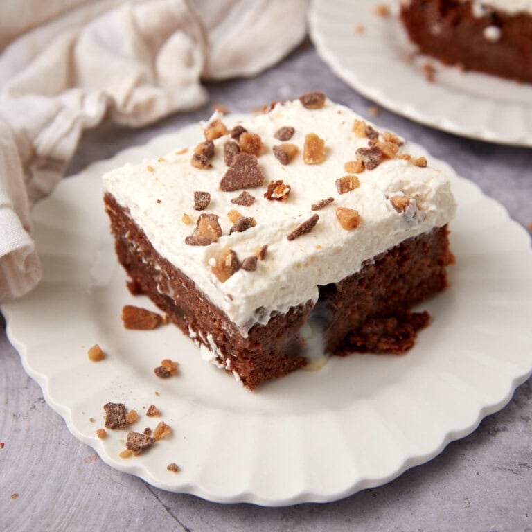 piece of heath bar cake on a white plate.