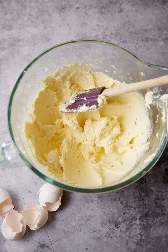 butter and sugar beaten in a glass bowl with a spatula.