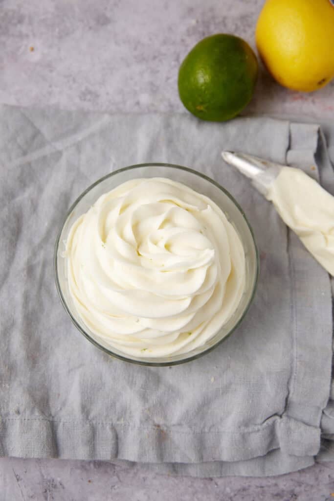 lemon lime frosting piped into a clear bowl.