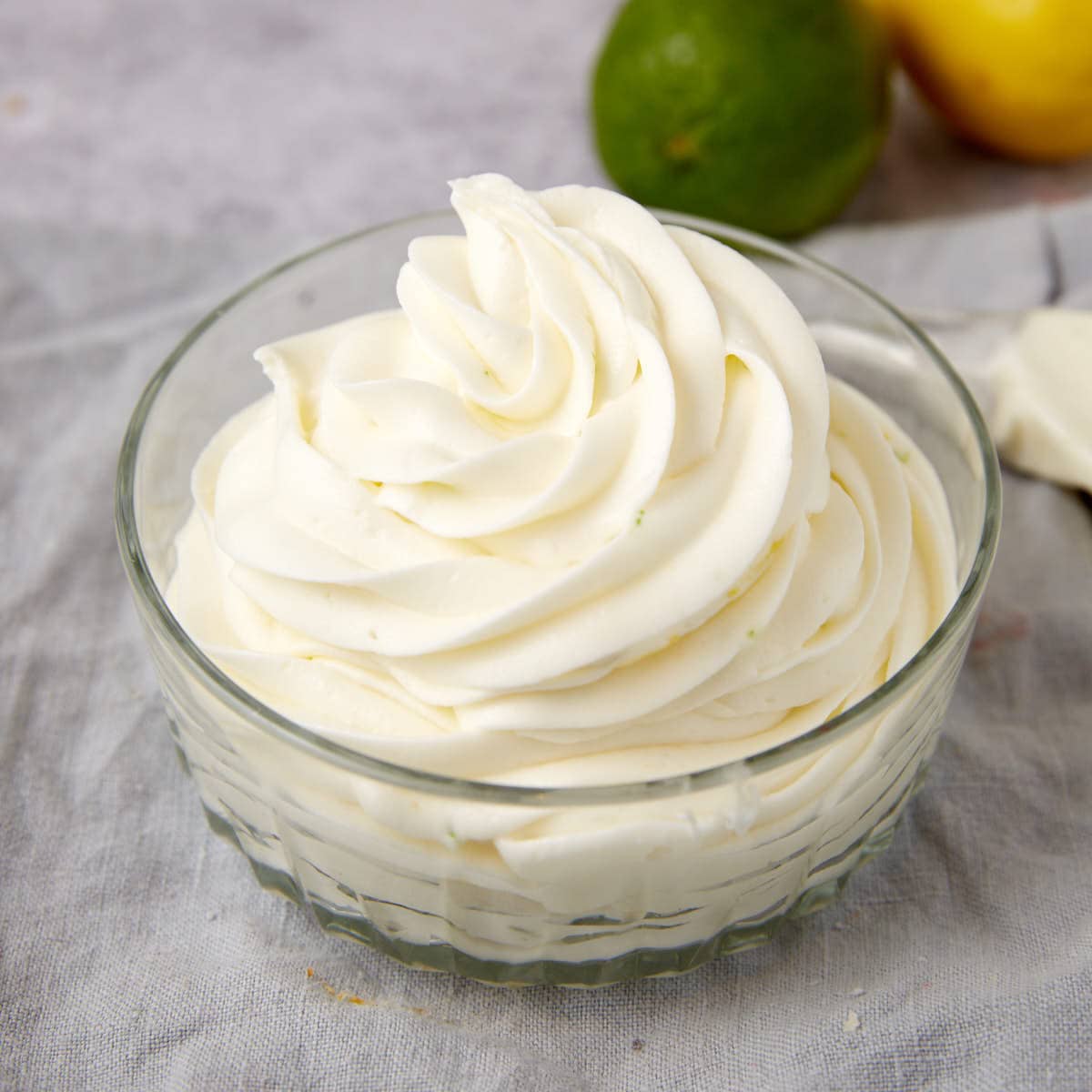 lemon lime frosting piped into a clear bowl.