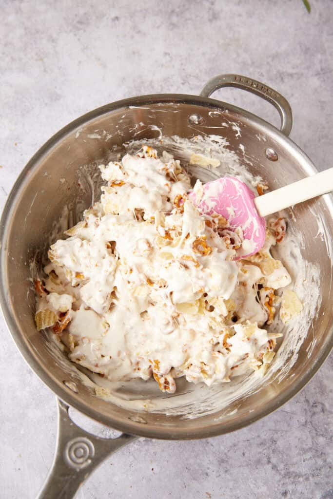 marshmallow square mixture being mixed in a saucepan with a spatula.