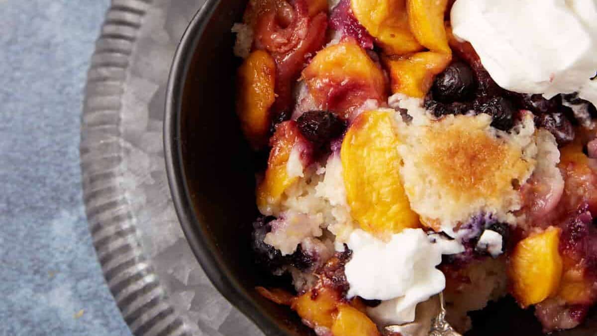 peach cobbler cake in a bowl.