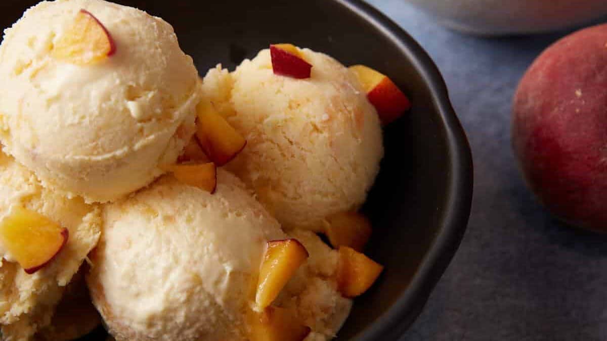 A bowl of peach ice cream scoops.