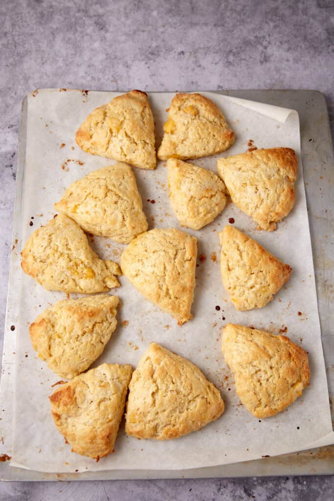 baked peach scones on a piece of parchment paper.