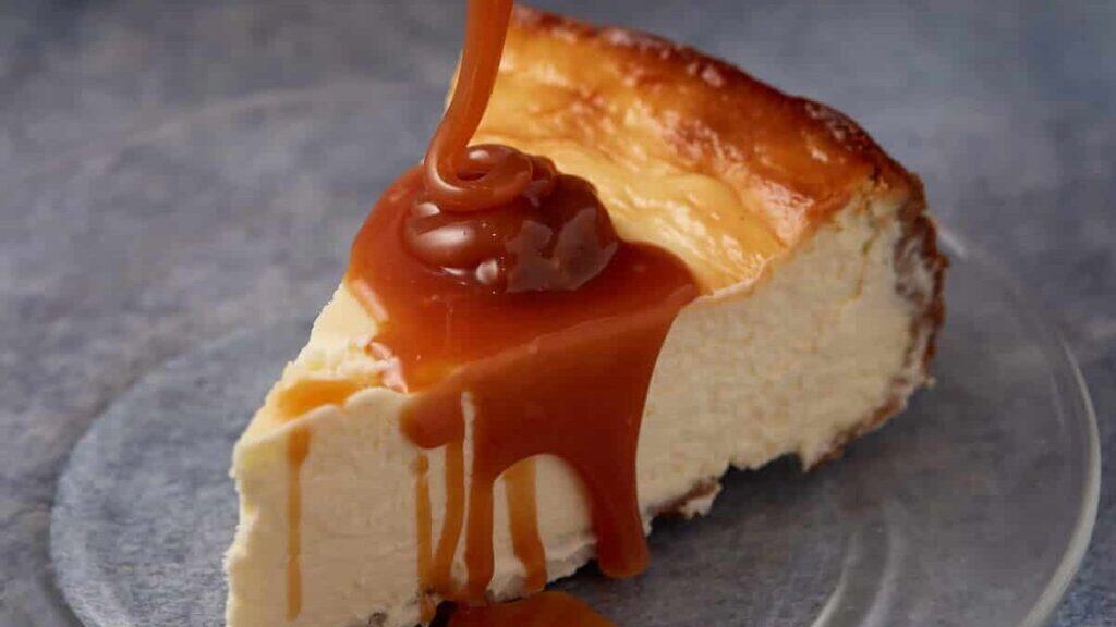 Caramel being poured over cheesecake.