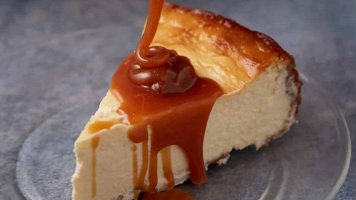 Caramel being poured over cheesecake.