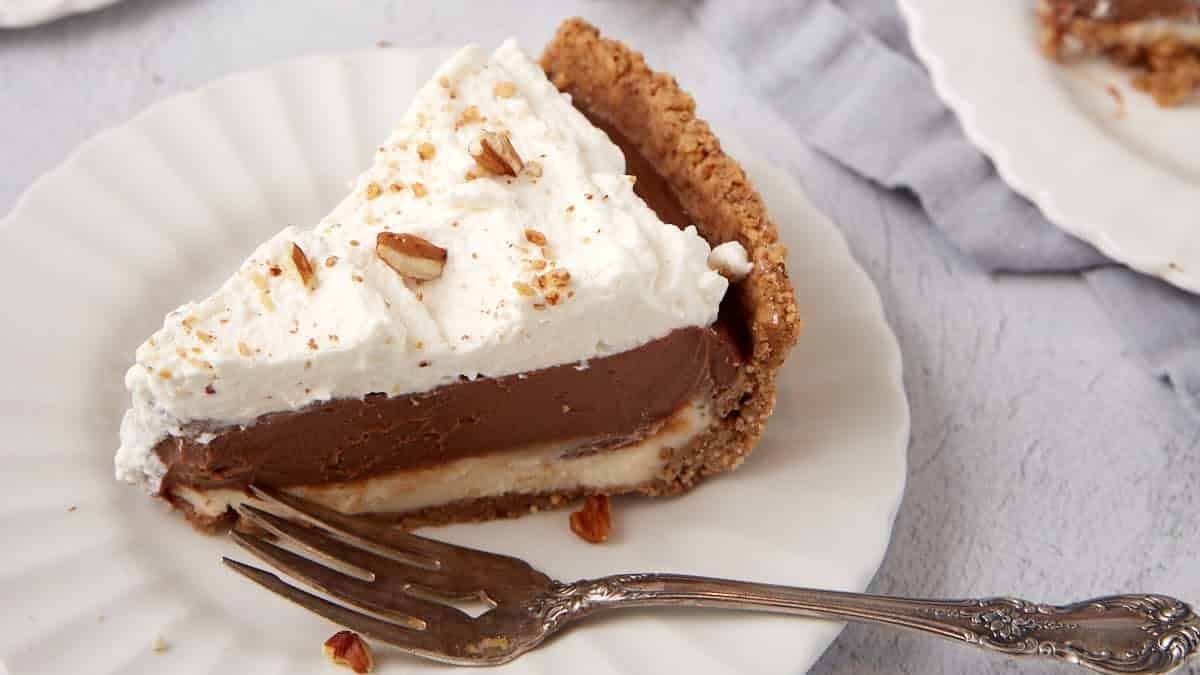 Slices of possum pie on white plates.