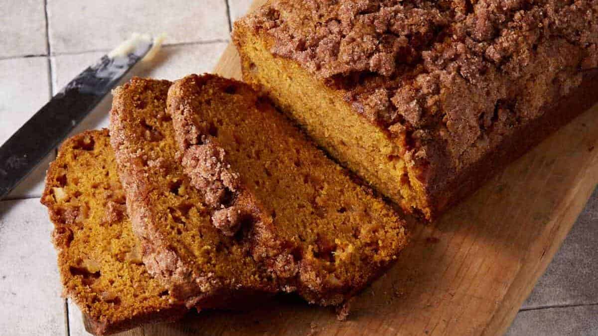 sliced pumpkin apple bread on a board.