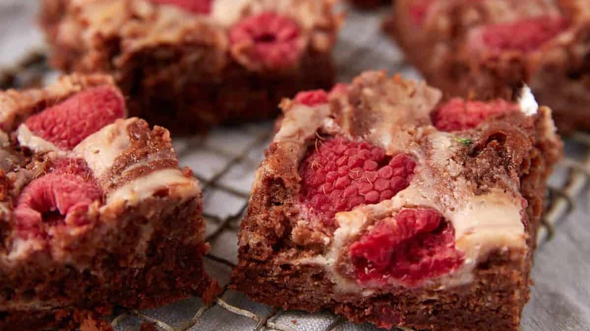 raspberry cream cheese brownies on a wire rack.