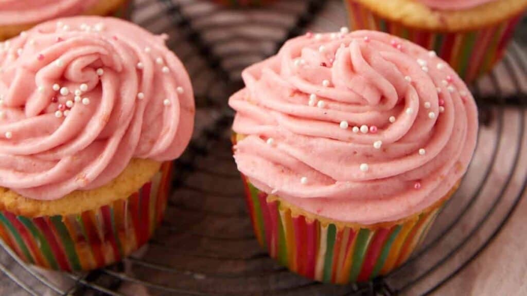raspberry cupcakes on a cupcake stand.