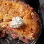 rhubarb custard pie with a slice taken out.