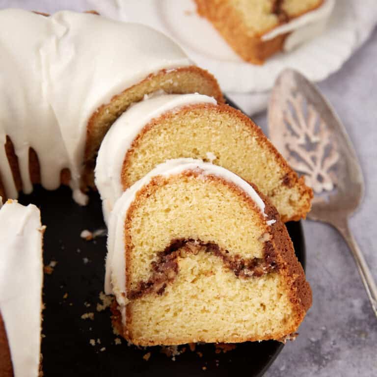 sliced sock it to me cake on a black plate.