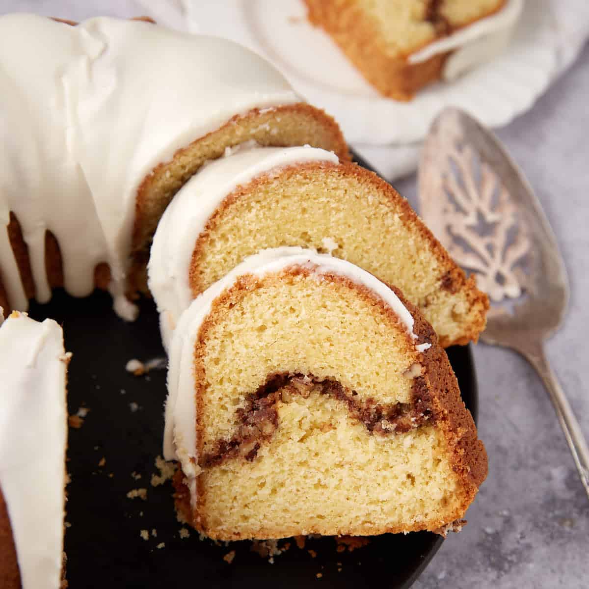 sliced sock it to me cake on a black plate.