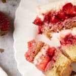 A bite of strawberry cake on a fork.