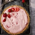 strawberry chiffon pie garnished with sliced and whole strawberries.