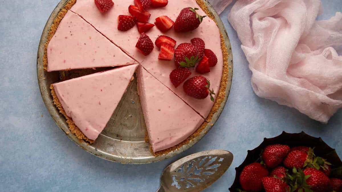 top view of sliced strawberry cream pie.